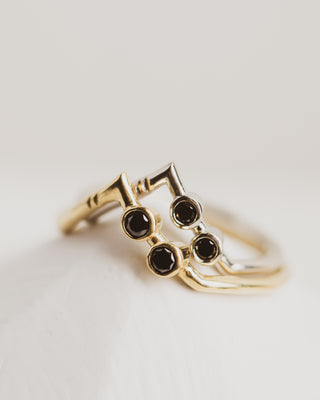 white and yellow gold rings with black diamonds