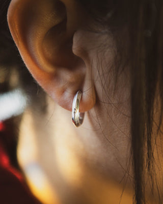 Silver hoop earrings on model