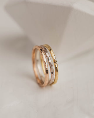 Three hammered rings in white rose and yellow gold