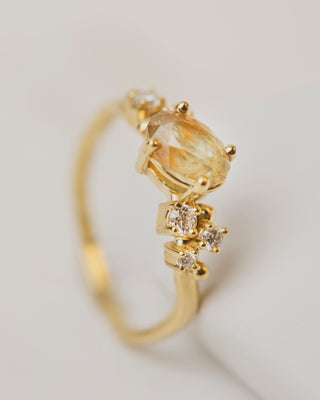 Oval yellow dot sapphire with five white diamonds in cluster