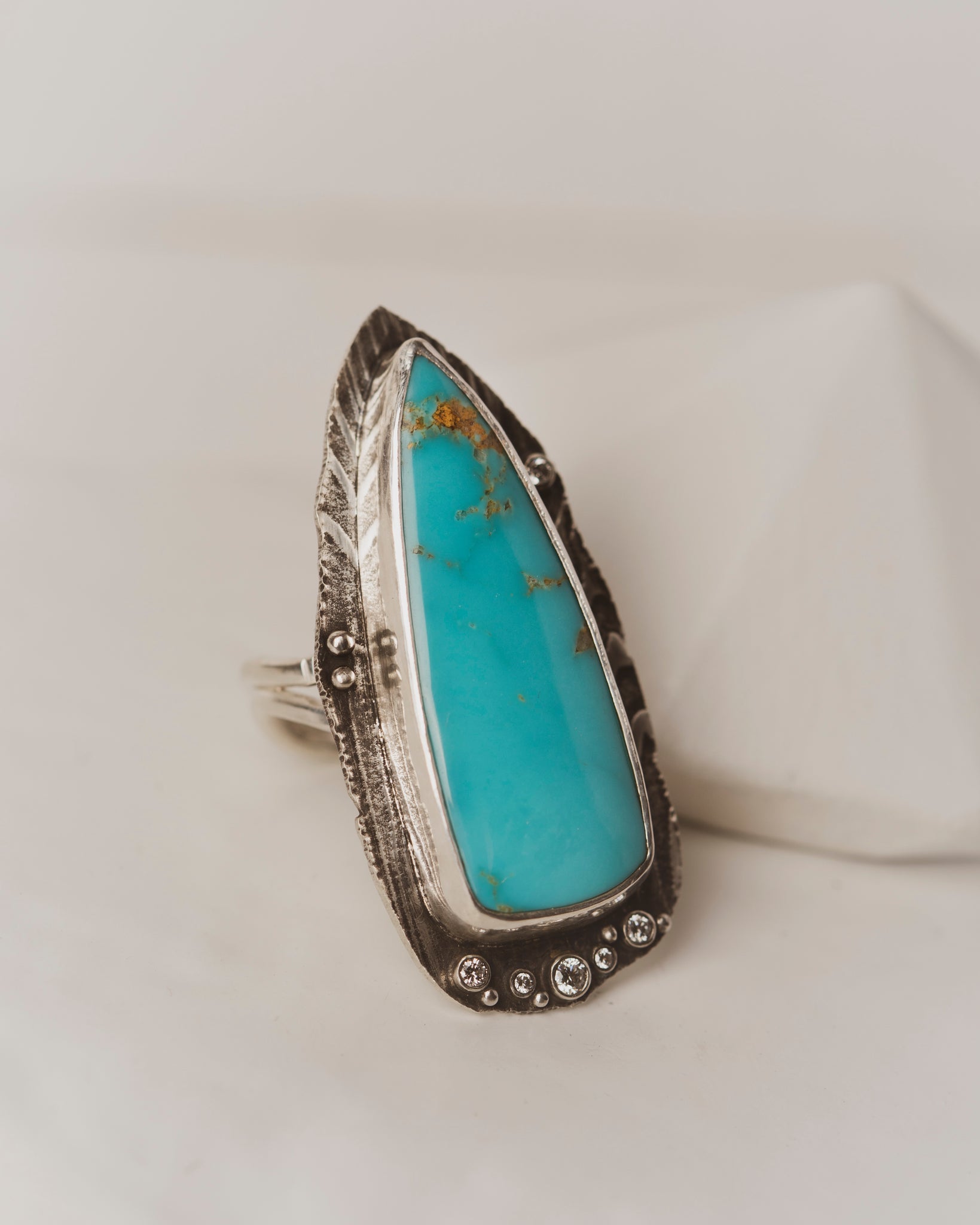 Arrow shaped Santa Maria Turquoise with five white diamonds in sterling silver